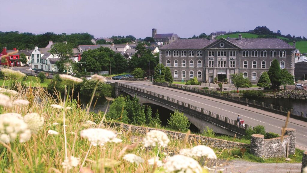 Belleek Pottery building beside a bridge and river in Belleek village, County Fermanagh