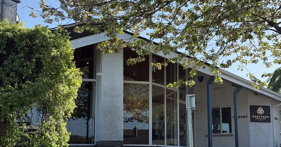 Exterior entrance of Boatyard Distillery in Enniskillen surrounded by trees and greenery