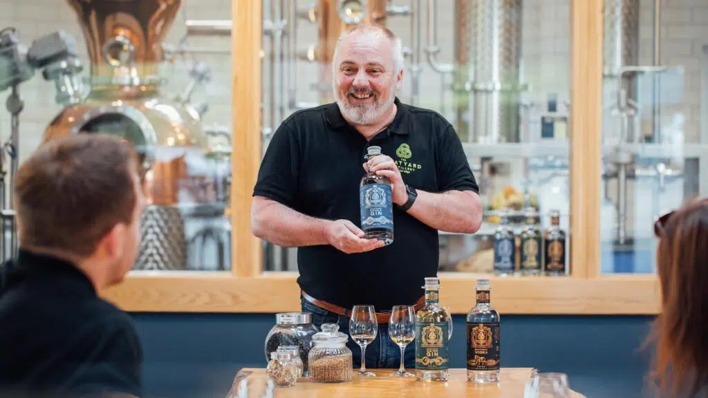 Guide presenting gin during a Boatyard Distillery tour experience near Enniskillen