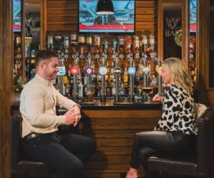 Couple enjoying a drink, conversation and relaxed atmosphere at the WV bar in the Westville Hotel
