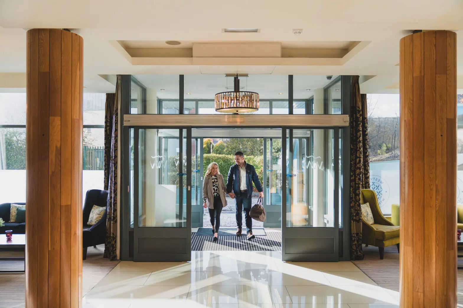 couple entering the elegant and spacious lobby at the Westville Hotel