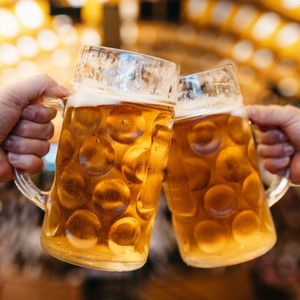 Beer steins raised during an Oktoberfest celebration