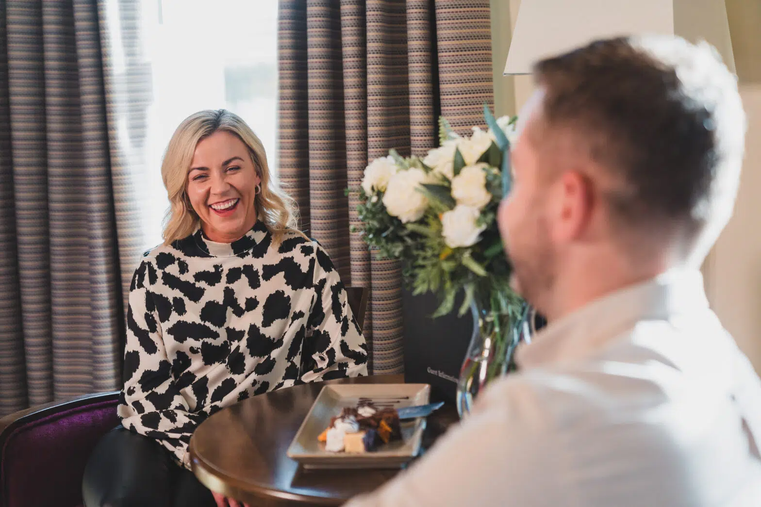 Couple relaxing in a guest room with welcome treats at Westville Hotel Enniskillen.