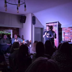 Stand-up comedian performing live during Boiler Room Comedy Club at The Westville Hotel, Enniskillen.