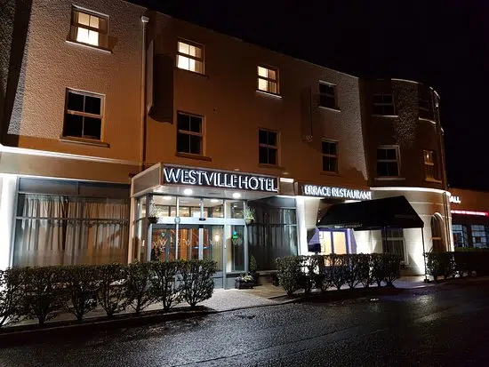 Exterior view of The Westville Hotel entrance in Enniskillen illuminated at night. - december hotel stay