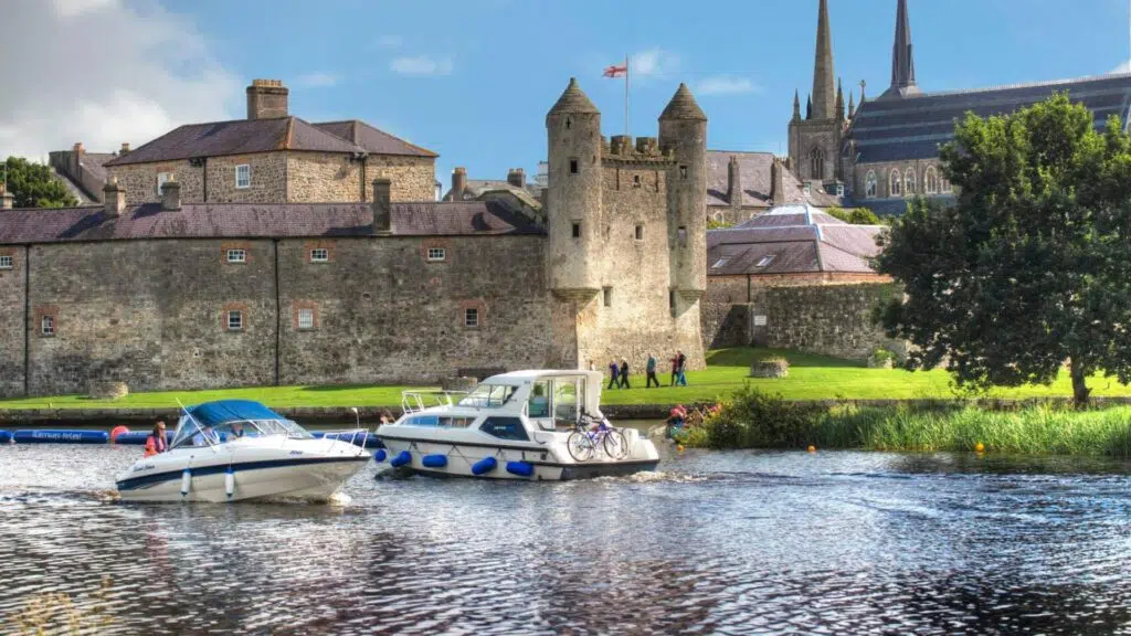 Summer getaway Enniskillen two boats on Lough Erne in front of Enniskillen Castle
